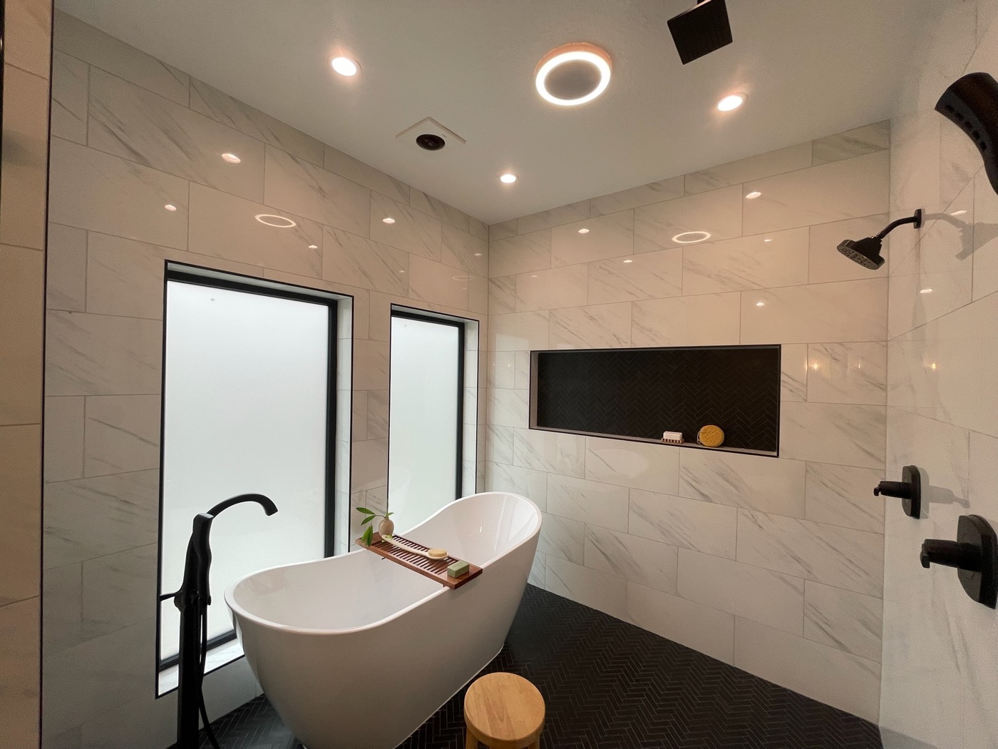 Marble-tiled bathroom with freestanding tub and walk-in shower