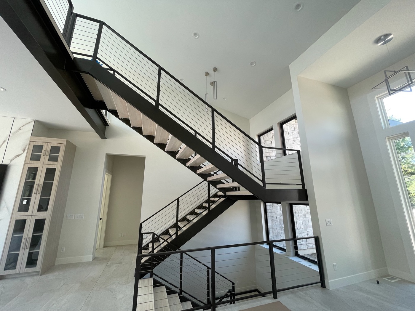 Floating steel staircase with cable railing