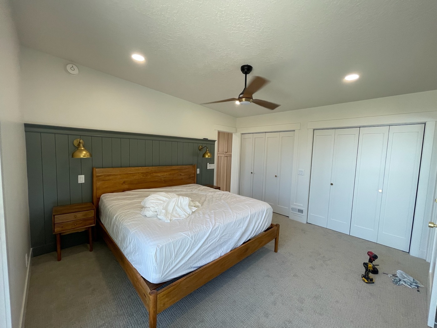 Bedroom with green paneled accent wall